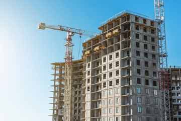 Fototapeta na wymiar Crane and high-rise residential building. Real Estate Construction