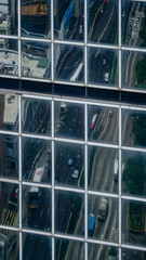 Overhead view of traffic on Gloucester Road reflected in the windows of a modern office block, Wan Chai, Hong Kong - 251801534