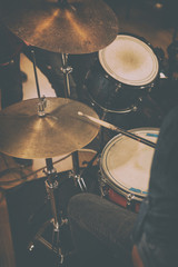 View from above of professional drums. Drummer playing on music instrument using drumsticks. Concept of repetition of rock band and performance.