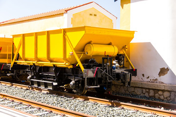 Ballast train. A large cargo yellow train at the station