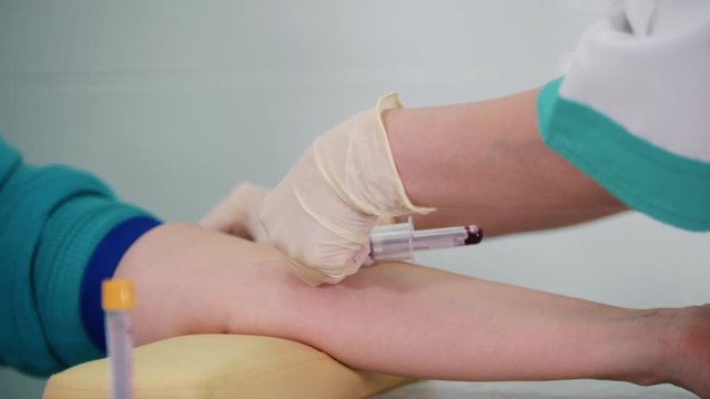 Taking a blood sample for testing in the tube. Collecting the blood