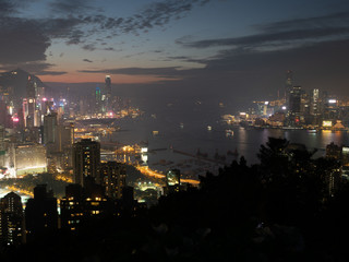 Fototapeta na wymiar Hong Kong skyline at twilight. High view overlooking Victoria Harbor including both Hong Kong island and Kowloon