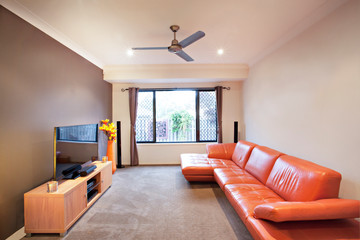 Red sofa near television and table