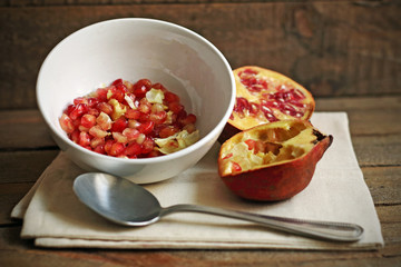 Tasty pomegranate on wood
