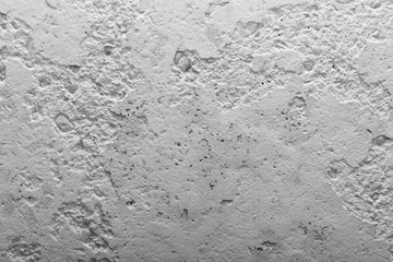Black and white concrete wall with pieces of plaster dropped off