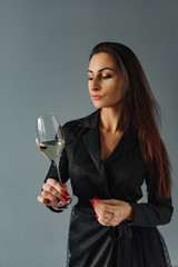 Party time and relax wine. Forever young. Portrait of lovely brunettes with wine in hands on blue background