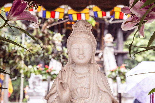 Female Buddha statue with Karana Mudra hand position, in front of the One Pillar Pagoda in Hanoi, Vietnam, Asia