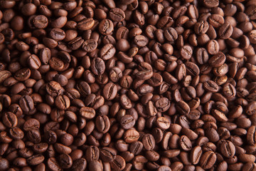  Whole grains of natural roasted coffee for the background.