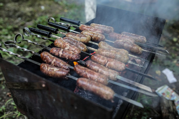 Homemade grilled sausages outdoors. Tasty food for barbecue party.