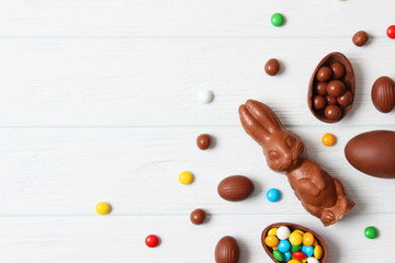  Easter composition with chocolate eggs and chocolate rabbit on wooden background, place for text 