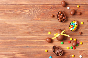  Easter composition with chocolate eggs and chocolate rabbit on wooden background, place for text 