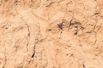 Dry cracked clay with sand, background texture