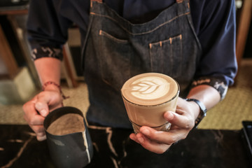 Obraz na płótnie Canvas Professional barista making caffe latte or cappuccino. Latte art.