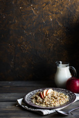 Buckwheat porridge with milk, apple, raisins and cashew nuts