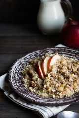 Buckwheat porridge with milk, apple, raisins and cashew nuts