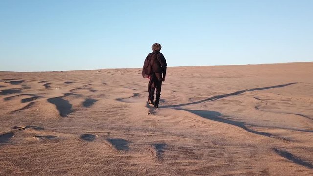 Young Boy Walking Alone in Desert