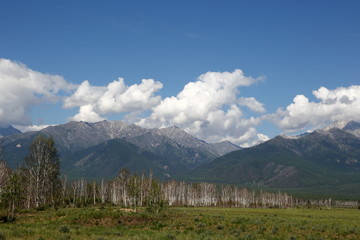The mountains of the Barguzin mountains, this valley of the Barguzin river Steppe in the floodplain of the Barguzin river, then-birch forest belt, and behind it-the mountains of Barguzin ridge and the