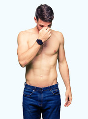 Fototapeta premium Handsome shirtless man showing nude chest tired rubbing nose and eyes feeling fatigue and headache. Stress and frustration concept.
