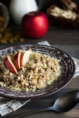 Buckwheat porridge with milk, apple, raisins and cashew nuts