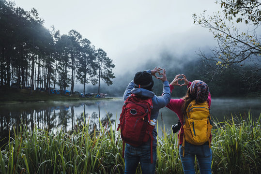 Couples who love to travel, take pictures Beatiful nature at Pang ung lake and pine forest at Mae Hong Son in Thailand.
