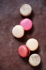 French assorted macarons cakes on a rectangular dish on a gray background. Colorful Small French cakes. Top View. 