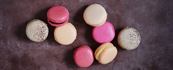 French assorted macarons cakes on a rectangular dish on a gray background. Colorful Small French cakes. Top View. 