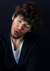 Fototapeta premium Curly man portrait on dark studio background