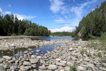 Siberian river Barguzin in the upper summer day in one of its turns between the slopes of the mountains