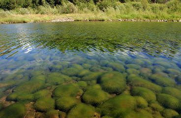 Siberian river Barguzin in the upper summer day in one of its turns between the slopes of the mountains