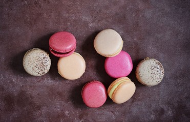 French assorted macarons cakes on a rectangular dish on a gray background. Colorful Small French cakes. Top View. 