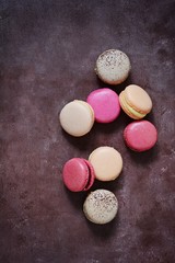 French assorted macarons cakes on a rectangular dish on a gray background. Colorful Small French cakes. Top View. 