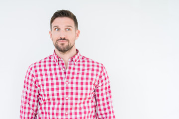 Young handsome man wearing shirt over isolated background smiling looking side and staring away thinking.