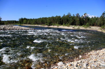 Siberian river Barguzin in the upper summer day in one of its turns between the slopes of the mountains