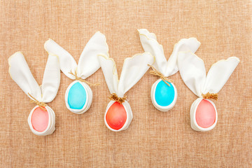 Easter bunny (rabbit) egg concept, table arrangement decoration. Pink (rosy) and blue eggs with...