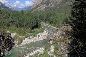 Mountain stream Alla deep in the valley of the mountains of the Barguzin range on a summer day