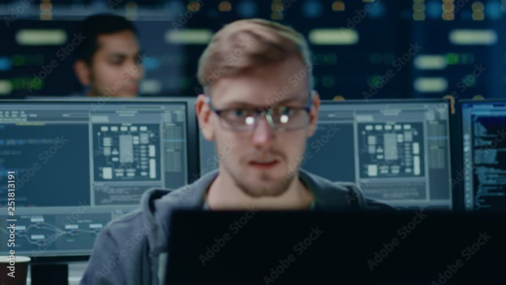 Fototapete Portraits of Two IT Specialists Working on Personal Computers with Sophisticated Software In Technologically Advanced Data Research Center. Transitioning Camera Rack Focus Between People.