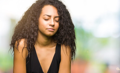Young beautiful girl with curly hair wearing fashion skirt with hand on stomach because...