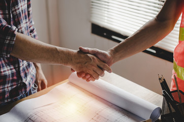 construction worker team hands shaking after consultation meeting to greeting start up plan new project contract in office center at construction site, teamwork, partnership and contractor concept