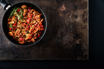 Chicken vegetable pan with rice, fresh ingredients and herbs