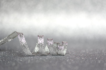 Silver ribbon on silver shiny background