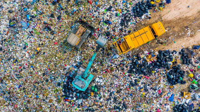Garbage pile  in trash dump or landfill, Aerial view garbage trucks unload garbage to a landfill,  global warming.