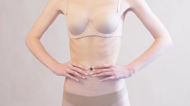 Anorexic girl showing stomach, insecurities, extremely low body weight, closeup