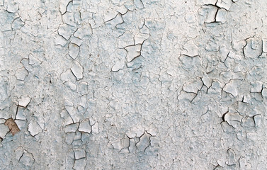 Old wooden background with remains of pieces of scraps of old paint on wood. Texture of an old tree, board with paint, vintage background peeling paint.