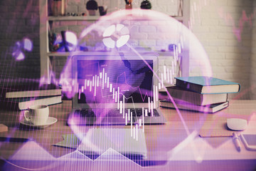 Double exposure of stock market chart and office desktop on background. financial strategy concept.