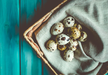 Easter composition with  quail eggs on color wooden background Space for text