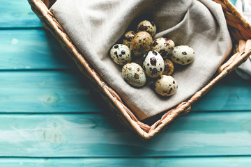 Easter composition with  quail eggs on color wooden background Space for text