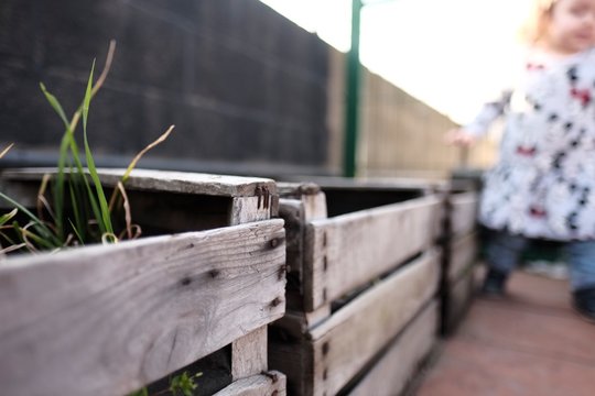 Toddler girl in an urban garden, eco gardening