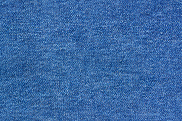 Jeans background denim pattern. Classic dark blue stonewashed fabric texture. Background of jeans canvas close up.