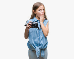 Young beautiful girl taking photos using vintage camera over isolated background cover mouth with hand shocked with shame for mistake, expression of fear, scared in silence, secret concept