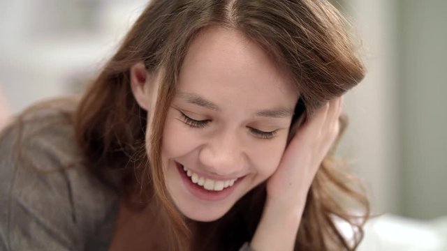 Happy woman face. Smiling woman touching hair. Portrait of cheerful girl